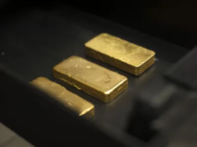 Three cast gold bars lined up after melting